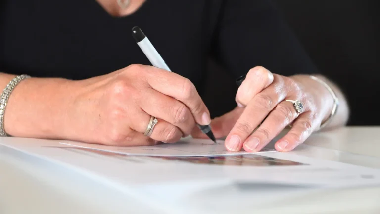 Woman writing at a power of attorney