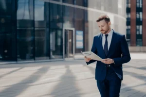 Focused formally dressed business person reading about S corporation
