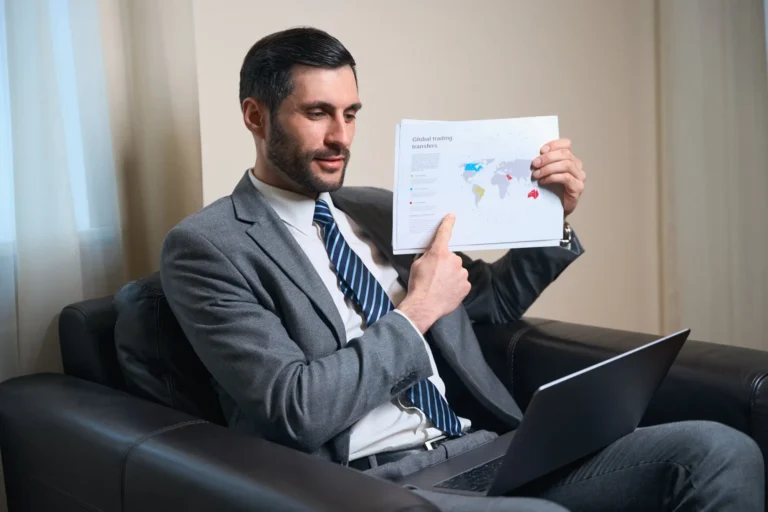 Man holds a map of the world in his hands