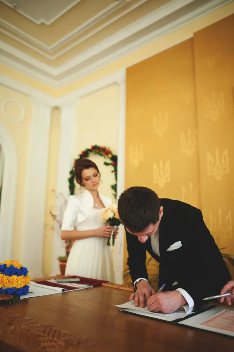 Wedding. The groom puts his signature in the marriage registry office