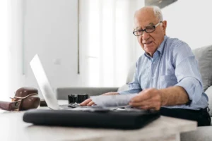 Senior man working with a computer searching notary public center