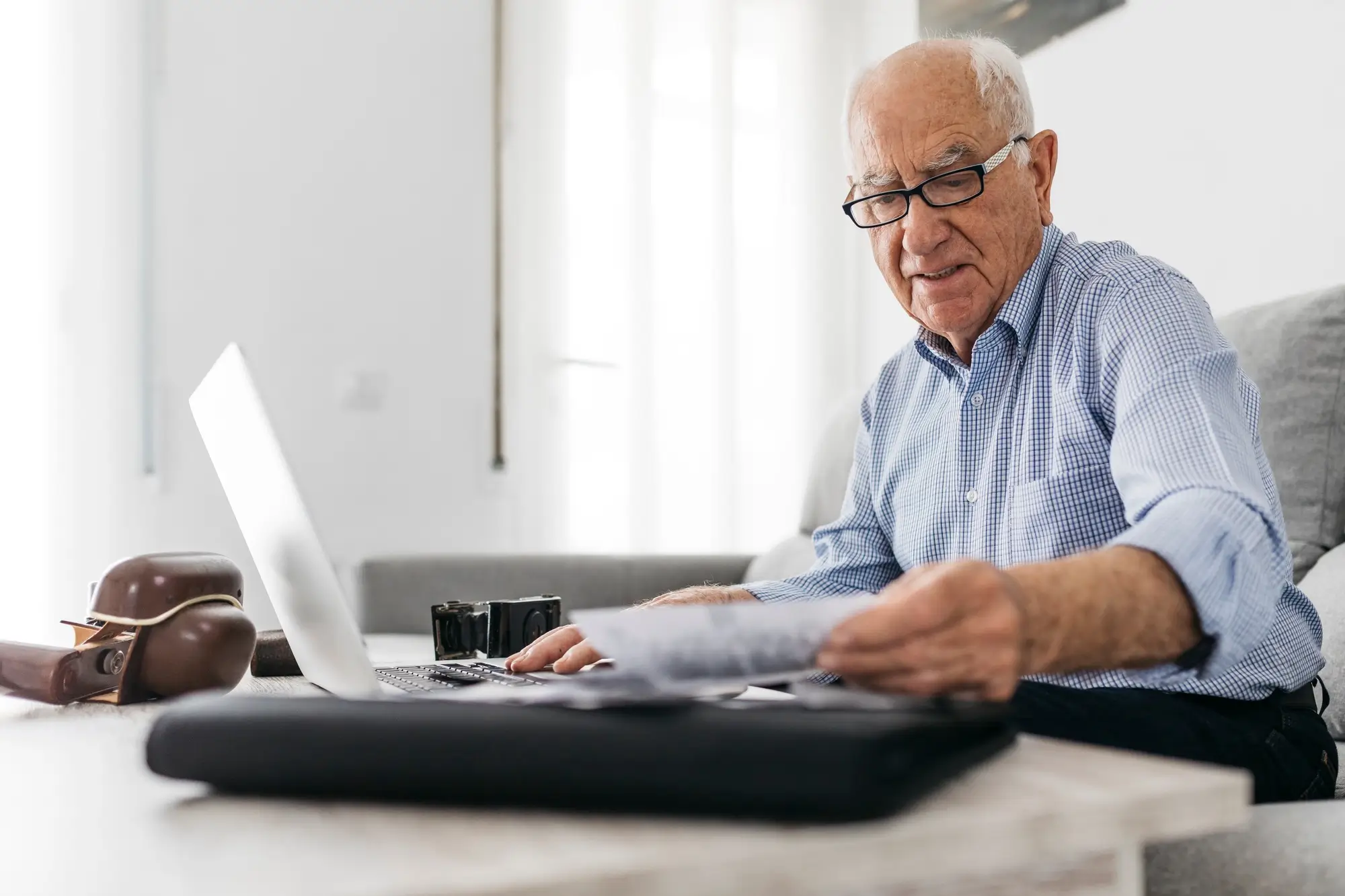 Senior man working with a computer searching notary public center